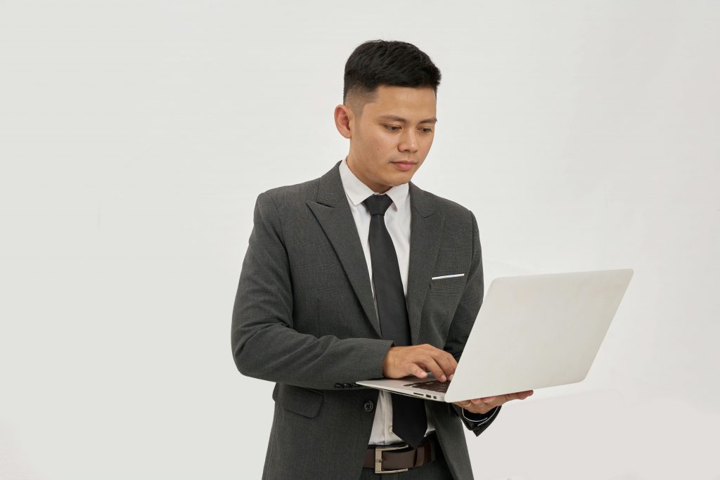 man in a suit using a laptop
