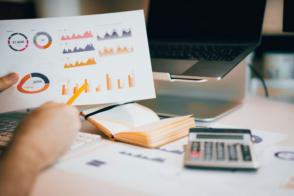 close-up of a person holding a document with charts
